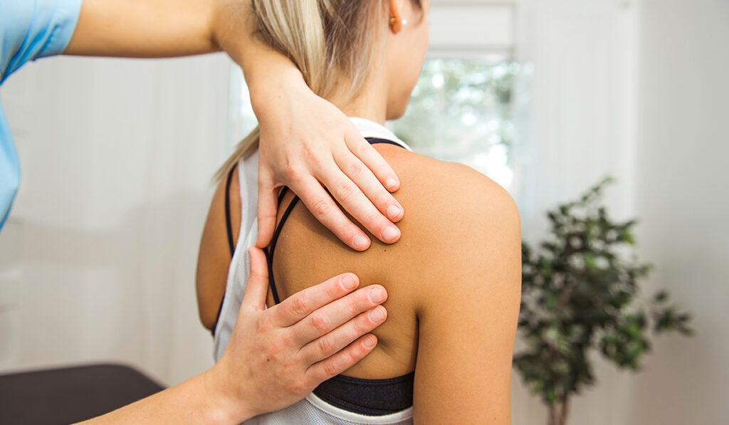 A woman receiving chiropractic treatment 