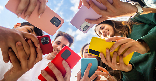 Young group of people using social media platform on mobile phone 