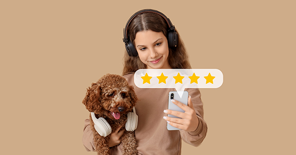 Young girl with dog and mobile phone giving feedback