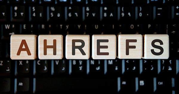 Ahrefs spelled with wooden blocks on black computer keyboard