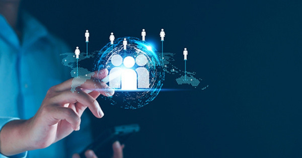 Business person using digital interface to connect global people icons.