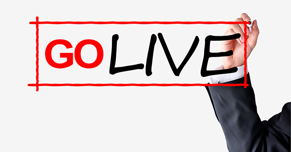 Hand writing go live concept for project launch.