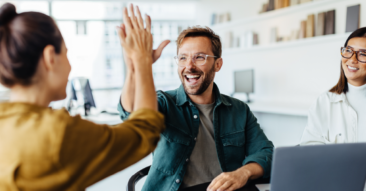 office workers giving each other a high 5