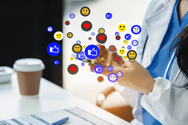 A doctor uses a smartphone as floating social media reaction icons appear around the screen.