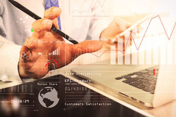 A person reviews digital healthcare marketing analytics on a transparent data dashboard overlaying a laptop screen.