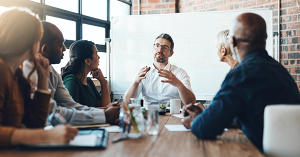 manager providing training to his staff during meeting