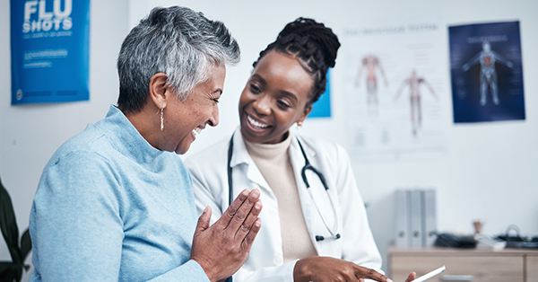 a female doctor talking to the elderly patient