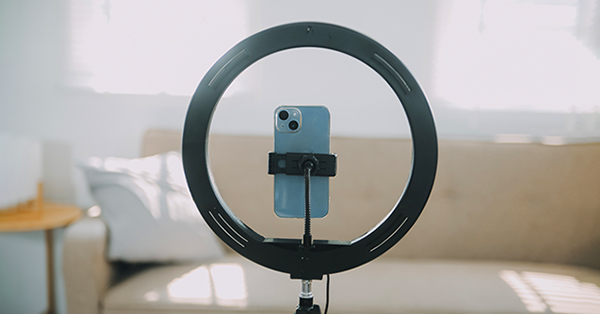 Smartphone mounted in ring light for video recording setup
