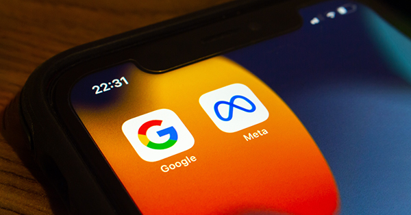 Closeup icons of Google and Meta on an iPhone
